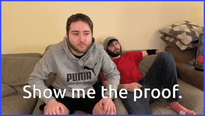 Two Men Are Sitting On A Couch And One Has A Puma Sweatshirt On GIF