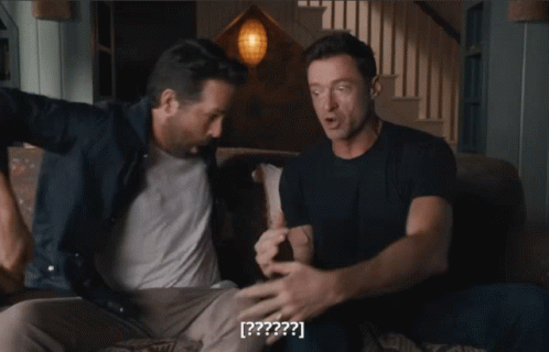 Two Men Are Sitting On A Couch And One Of Them Says [ ? ] On The Screen GIF