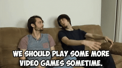 Two Men Are Sitting On A Couch And One Of Them Says We Should Play Some More Video Games Sometime GIF