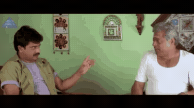 Two Men Are Sitting On A Couch And Talking To Each Other . GIF