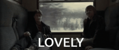 Two Men Are Sitting On A Couch With The Word Lovely In The Corner GIF