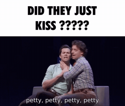 Two Men Are Sitting On A Couch With The Words Did They Just Kiss Behind Them GIF