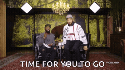 Two Men Are Sitting On A Couch With The Words Time For You To Go GIF