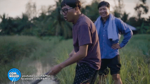 Two Men Are Standing In A Field With A Youtube.com Logo In The Corner GIF