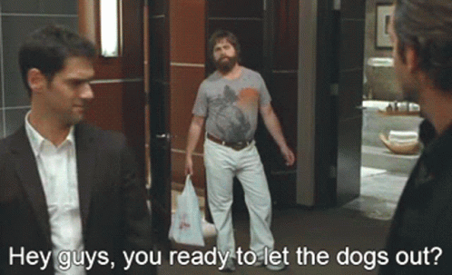 Two Men Are Standing In A Hallway With The Words Hey Guys You Ready To Let The Dogs Out Above Them GIF