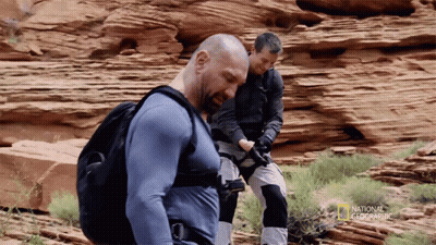 Two Men Are Standing In A Rocky Area With National Geographic Written On The Bottom Right GIF