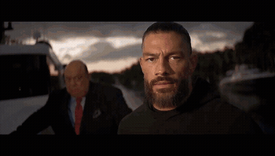 Two Men Are Standing In A Wrestling Ring And One Has A Shirt That Says Tribal Chief On It GIF