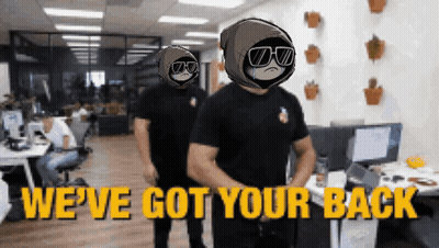Two Men Are Standing In An Office With The Words We 'Ve Got Your Back On The Bottom GIF