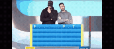 Two Men Are Standing In Front Of A Board With The Letters F And P On It GIF