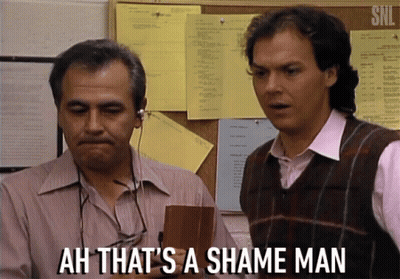 Two Men Are Standing In Front Of A Bulletin Board With The Words Ah That 'S A Shame Man GIF