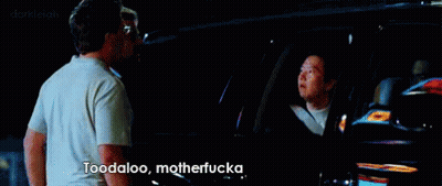Two Men Are Standing In Front Of A Car And One Of Them Is Saying Toodaloo Motherfuckaa GIF