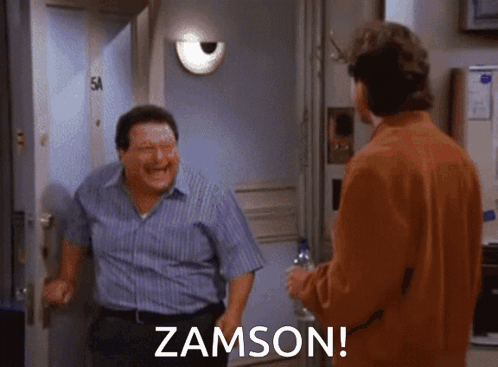 Two Men Are Standing In Front Of A Door And One Of Them Is Laughing And The Other Is Saying Zamson GIF