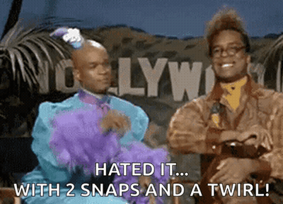 Two Men Are Standing In Front Of A Hollywood Sign GIF