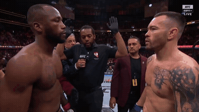Two Men Are Standing In Front Of A Referee Wearing A Ufc Shirt GIF