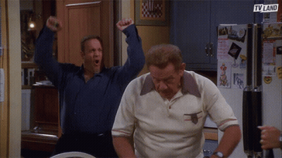 Two Men Are Standing In Front Of A Refrigerator That Says Tv Land On It GIF