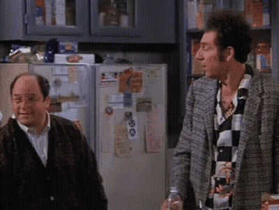 Two Men Are Standing In Front Of A Refrigerator With A Sticker On It That Says ' I Love You ' GIF