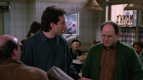 Two Men Are Standing In Front Of A Sign That Says ' 2Hkom ' On It GIF