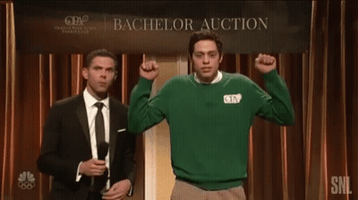 Two Men Are Standing In Front Of A Sign That Says Bachelor Auction GIF