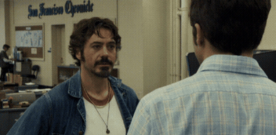 Two Men Are Standing In Front Of A Sign That Says San Francisco Opsmide GIF