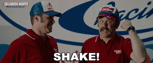 Two Men Are Standing In Front Of A Sign That Says Talladega Nights On It GIF