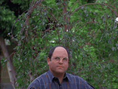 Two Men Are Standing In Front Of A Tree With A Frisbee Flying In The Air GIF