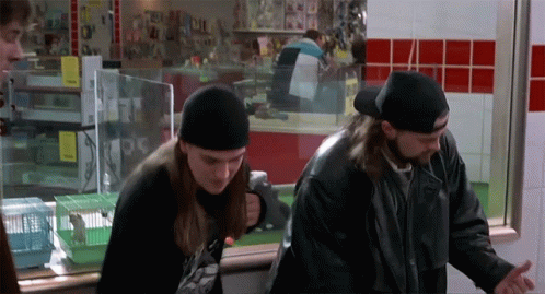 Two Men Are Standing In Front Of A Window With A Sign That Says ' A ' On It GIF