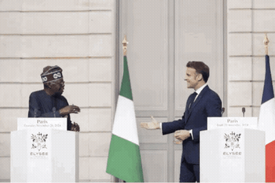 Two Men Are Standing In Front Of Podiums That Say Elysee GIF