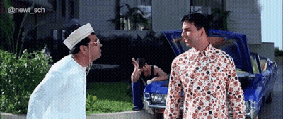 Two Men Are Standing Next To A Blue Car With The Hood Up . GIF