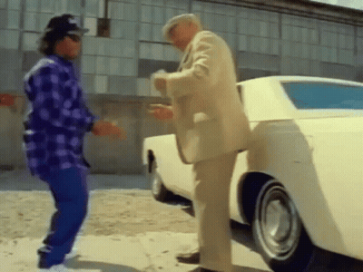 Two Men Are Standing Next To A White Car . GIF