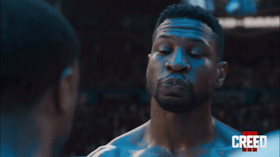 Two Men Are Standing Next To Each Other And Looking At Each Other In A Boxing Ring . GIF