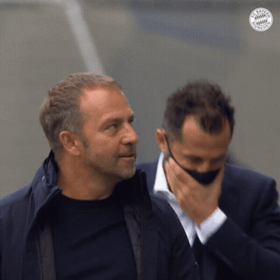 Two Men Are Standing Next To Each Other And One Has A Bayern Munich Logo On His Jacket GIF