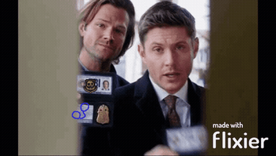 Two Men Are Standing Next To Each Other And One Has A Cbs Badge On His Chest GIF
