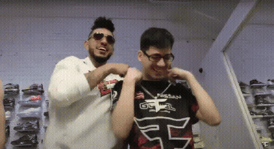 Two Men Are Standing Next To Each Other And One Has A Shirt That Says Nissan On It GIF