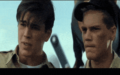 Two Men Are Standing Next To Each Other And One Has A Tooth In His Mouth GIF