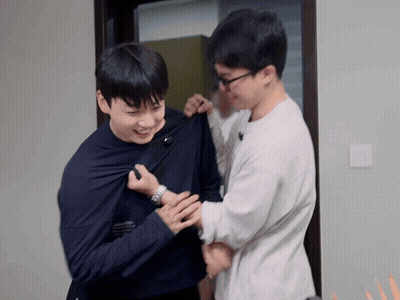 Two Men Are Standing Next To Each Other And One Has A Watch On GIF