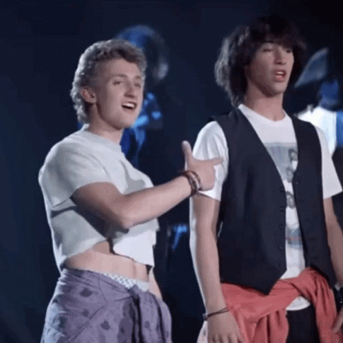 Two Men Are Standing Next To Each Other And One Is Pointing At The Other GIF