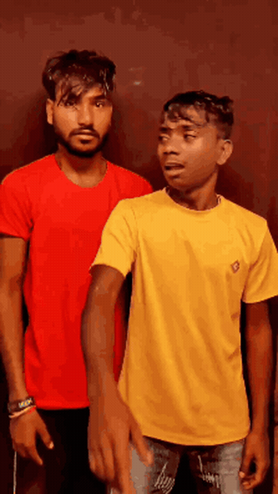 Two Men Are Standing Next To Each Other And One Is Wearing A Yellow Shirt GIF
