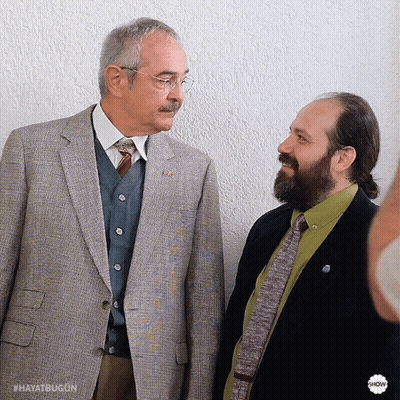 Two Men Are Standing Next To Each Other And One Of Them Has A Badge That Says Hayatbugon GIF