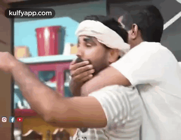 Two Men Are Standing Next To Each Other And One Of Them Is Covering His Mouth With His Hand . GIF