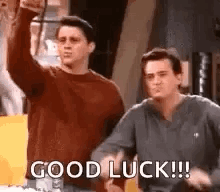 Two Men Are Standing Next To Each Other And One Of Them Is Giving A Thumbs Up . GIF