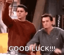 Two Men Are Standing Next To Each Other And One Of Them Is Giving A Thumbs Up And The Other Is Saying `` Good Luck '' . GIF