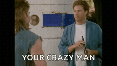 Two Men Are Standing Next To Each Other And One Of Them Is Holding A Gun And The Other Is Saying `` Your Crazy Man '' . GIF