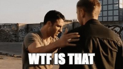Two Men Are Standing Next To Each Other And One Of Them Is Holding The Other 'S Arm . GIF