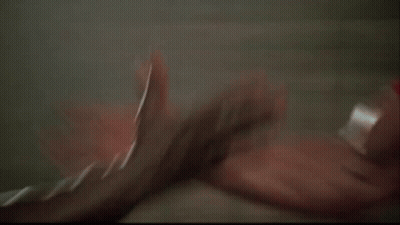 Two Men Are Standing Next To Each Other And One Of Them Is Holding The Other 'S Hand . GIF