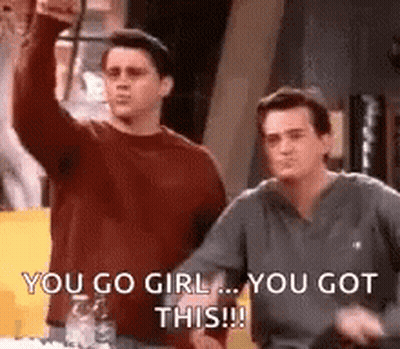 Two Men Are Standing Next To Each Other And One Of Them Is Raising His Fist In The Air . GIF