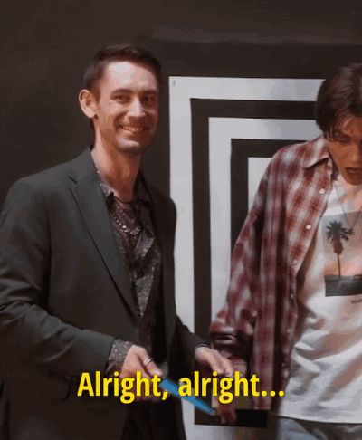 Two Men Are Standing Next To Each Other And One Of Them Is Saying Alright Alright GIF