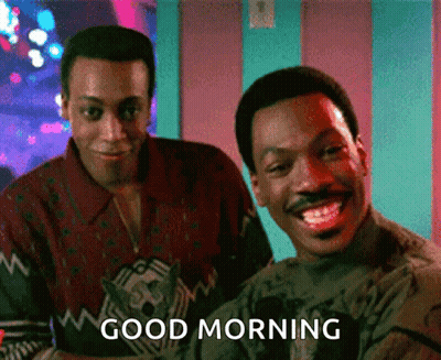 Two Men Are Standing Next To Each Other And One Of Them Is Smiling And The Other Is Saying Good Morning GIF
