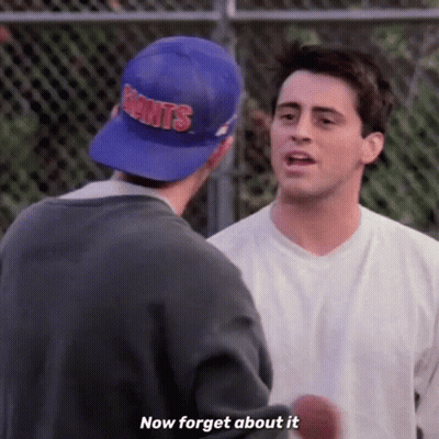 Two Men Are Standing Next To Each Other And One Of Them Is Wearing A Blue Hat That Says Giants . GIF