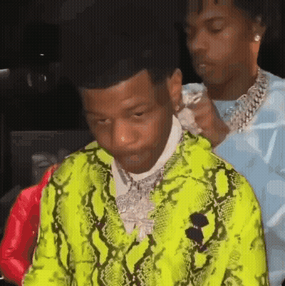 Two Men Are Standing Next To Each Other And One Of Them Is Wearing A Neon Green Snakeskin Jacket . GIF