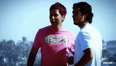 Two Men Are Standing Next To Each Other And One Of Them Is Wearing A Pink Shirt That Says ' Rbd.gif ' GIF
